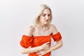 Young caucasian woman standing over isolated background with hand on stomach because indigestion, painful illness feeling unwell Royalty Free Stock Photo