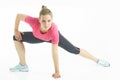 Young caucasian woman stretching legs warm up in studio isolated on white background