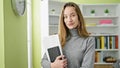 Young caucasian woman student smiling confident holding books at library university Royalty Free Stock Photo