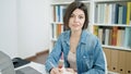 Young caucasian woman student using laptop writing on notebook at university classroom Royalty Free Stock Photo