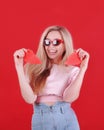 Young caucasian woman in sunglasses with broken red heart in hands. Royalty Free Stock Photo
