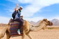 Young caucasian woman tourist riding on camel Royalty Free Stock Photo