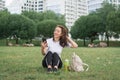 Young caucasian woman using her smartphone for internet surfing lying on a green grass Royalty Free Stock Photo