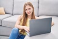 Young caucasian woman using laptop sitting on floor at home Royalty Free Stock Photo