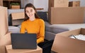 Young caucasian woman using laptop sitting on floor at new home Royalty Free Stock Photo