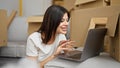 Young caucasian woman using laptop sitting on floor at new home Royalty Free Stock Photo