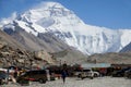 Young Caucasian woman walks across a parking lot under the snowy Mount Everest.