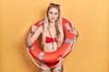 Young caucasian woman wearing bikini and holding lifeguard float doing happy thumbs up gesture with hand Royalty Free Stock Photo