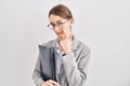 Young caucasian woman wearing business clothes and glasses pointing to the eye watching you gesture, suspicious expression Royalty Free Stock Photo