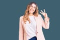 Young caucasian woman wearing business clothes showing and pointing up with fingers number three while smiling confident and happy Royalty Free Stock Photo