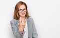 Young caucasian woman wearing business style and glasses beckoning come here gesture with hand inviting welcoming happy and Royalty Free Stock Photo