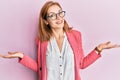 Young caucasian woman wearing business style and glasses smiling showing both hands open palms, presenting and advertising Royalty Free Stock Photo