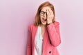 Young caucasian woman wearing business style and glasses yawning tired covering half face, eye and mouth with hand Royalty Free Stock Photo