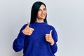 Young caucasian woman wearing casual clothes success sign doing positive gesture with hand, thumbs up smiling and happy Royalty Free Stock Photo