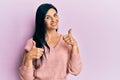 Young caucasian woman wearing casual clothes success sign doing positive gesture with hand, thumbs up smiling and happy Royalty Free Stock Photo