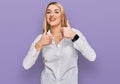 Young caucasian woman wearing casual clothes success sign doing positive gesture with hand, thumbs up smiling and happy Royalty Free Stock Photo