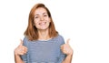 Young caucasian woman wearing casual clothes success sign doing positive gesture with hand, thumbs up smiling and happy Royalty Free Stock Photo