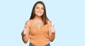 Young caucasian woman wearing casual clothes success sign doing positive gesture with hand, thumbs up smiling and happy Royalty Free Stock Photo