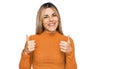 Young caucasian woman wearing casual clothes success sign doing positive gesture with hand, thumbs up smiling and happy Royalty Free Stock Photo
