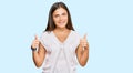 Young caucasian woman wearing casual clothes success sign doing positive gesture with hand, thumbs up smiling and happy Royalty Free Stock Photo