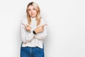Young caucasian woman wearing casual winter sweater pointing to both sides with fingers, different direction disagree Royalty Free Stock Photo