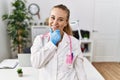 Young caucasian woman wearing doctor uniform and stethoscope at the clinic looking confident at the camera smiling with crossed Royalty Free Stock Photo