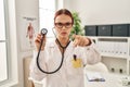 Young caucasian woman wearing doctor uniform using stethoscope pointing with finger to the camera and to you, confident gesture Royalty Free Stock Photo