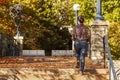 A young woman walking in the park covered with autumn colors Royalty Free Stock Photo