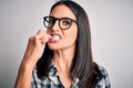 Young caucasian woman wearing glasses brushing her teeth using tooth brush and oral paste, cleaning teeth and tongue as healthy Royalty Free Stock Photo