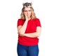 Young caucasian woman wearing princess crown thinking looking tired and bored with depression problems with crossed arms