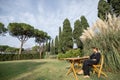 Woman working online on a green lawn outdoors Royalty Free Stock Photo