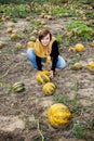 Young caucasian woman working on the pumpkin field Royalty Free Stock Photo