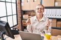 Young caucasian woman working at small business ecommerce using laptop excited for success with arms raised and eyes closed Royalty Free Stock Photo