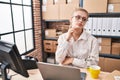 Young caucasian woman working at small business ecommerce using laptop with hand on chin thinking about question, pensive Royalty Free Stock Photo
