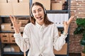 Young caucasian woman working at small business ecommerce wearing headset celebrating victory with happy smile and winner Royalty Free Stock Photo