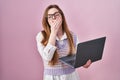 Young caucasian woman working using computer laptop bored yawning tired covering mouth with hand Royalty Free Stock Photo