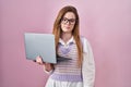 Young caucasian woman working using computer laptop looking sleepy and tired, exhausted for fatigue and hangover, lazy eyes in the Royalty Free Stock Photo