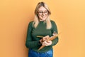 Young caucasian woman writing on checklist clipboard smiling with a happy and cool smile on face