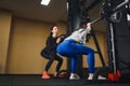 Young caucasian woman working out legs with barbell In gym with instructor. Personal female trainer Royalty Free Stock Photo