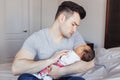 Young Caucasian worried father dad with his newborn mixed race Asian Chinese baby. Male man parent holding child daughter son. Royalty Free Stock Photo