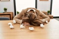 Young caucasian writer stressed with face on table at the office Royalty Free Stock Photo