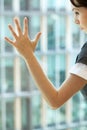 Young caucassian businesswoman standing against office window