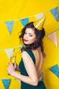 Young celebrating woman green dress, holding a glass of champagne. Royalty Free Stock Photo