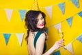 Young celebrating woman green dress, holding a glass of champagne. Royalty Free Stock Photo