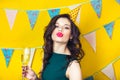 Young celebrating woman green dress, holding a glass of champagne. Royalty Free Stock Photo