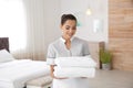 Young chambermaid with clean towels Royalty Free Stock Photo