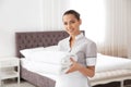 Young chambermaid with clean towels Royalty Free Stock Photo