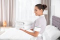 Young chambermaid with clean towels Royalty Free Stock Photo