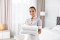 Young chambermaid with clean towels Royalty Free Stock Photo