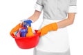 Young chambermaid holding basin with cleaning supplies Royalty Free Stock Photo